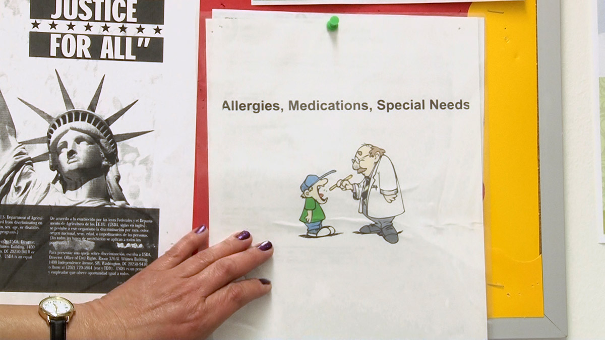 An allergies, medications, and special-needs packet is posted on a bulletin board