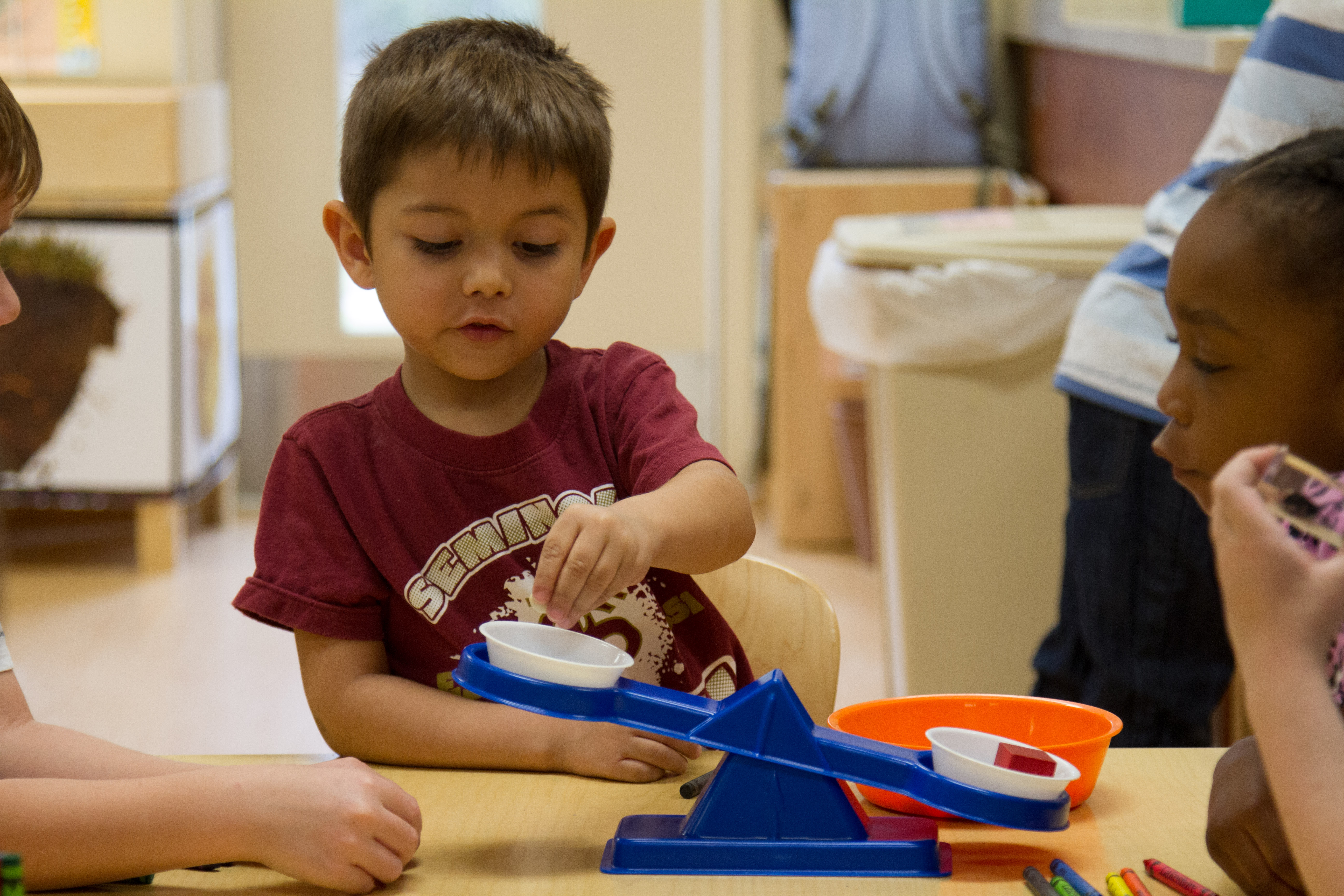 Boy playing with other preschool children