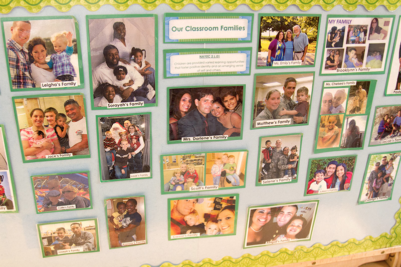 A bulletin board at a center displays photos of the children's families