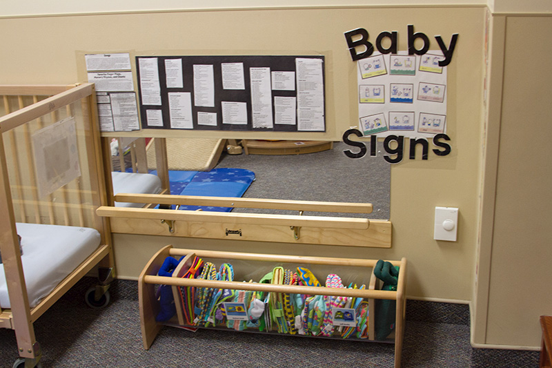 Information about infant development is displayed on the wall of the center