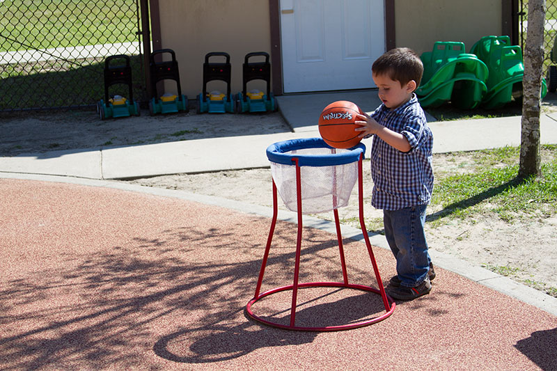 toddler playing basketball