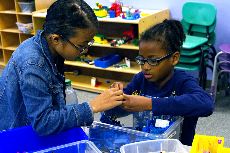 Two children play with legos