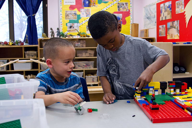 Two children play with legos