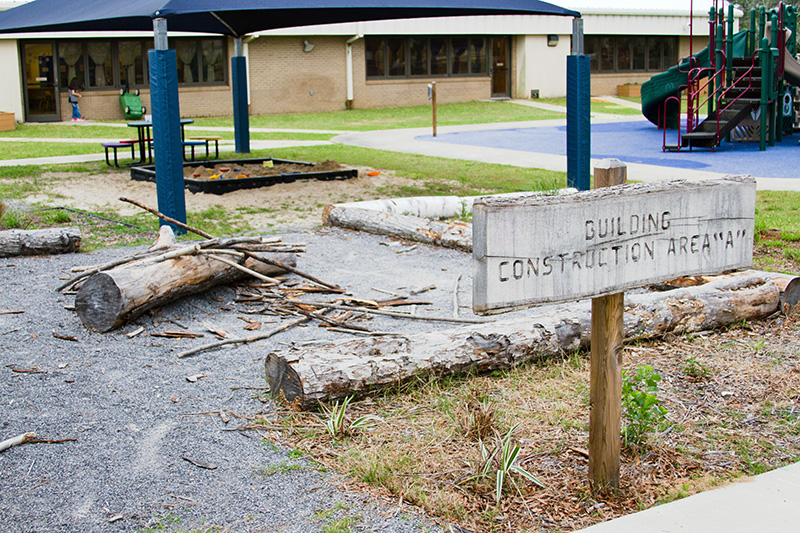 An outdoor play area with materials for building