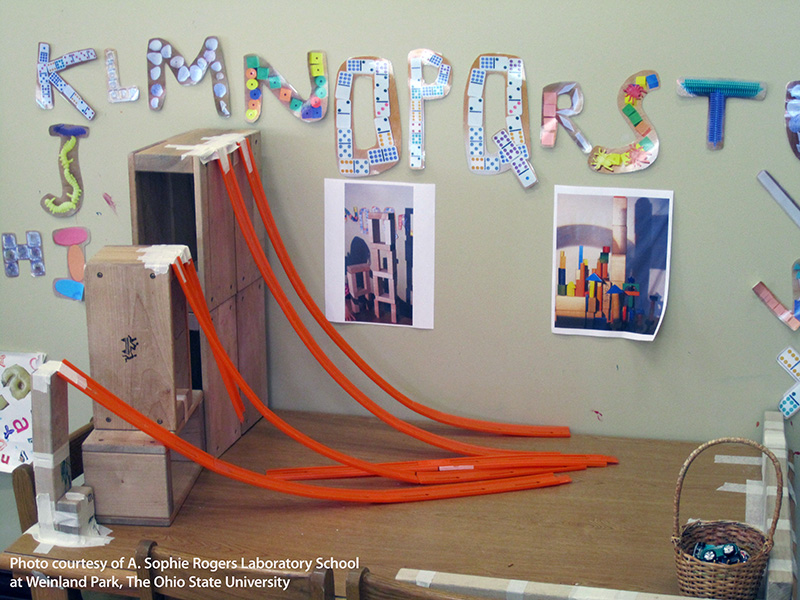 Toy car ramps are set up on a table