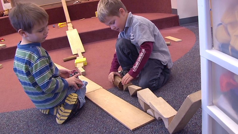 Boys playing with wooden blocks