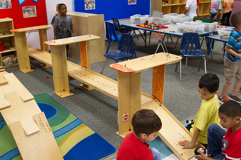 Children play with wood block structures